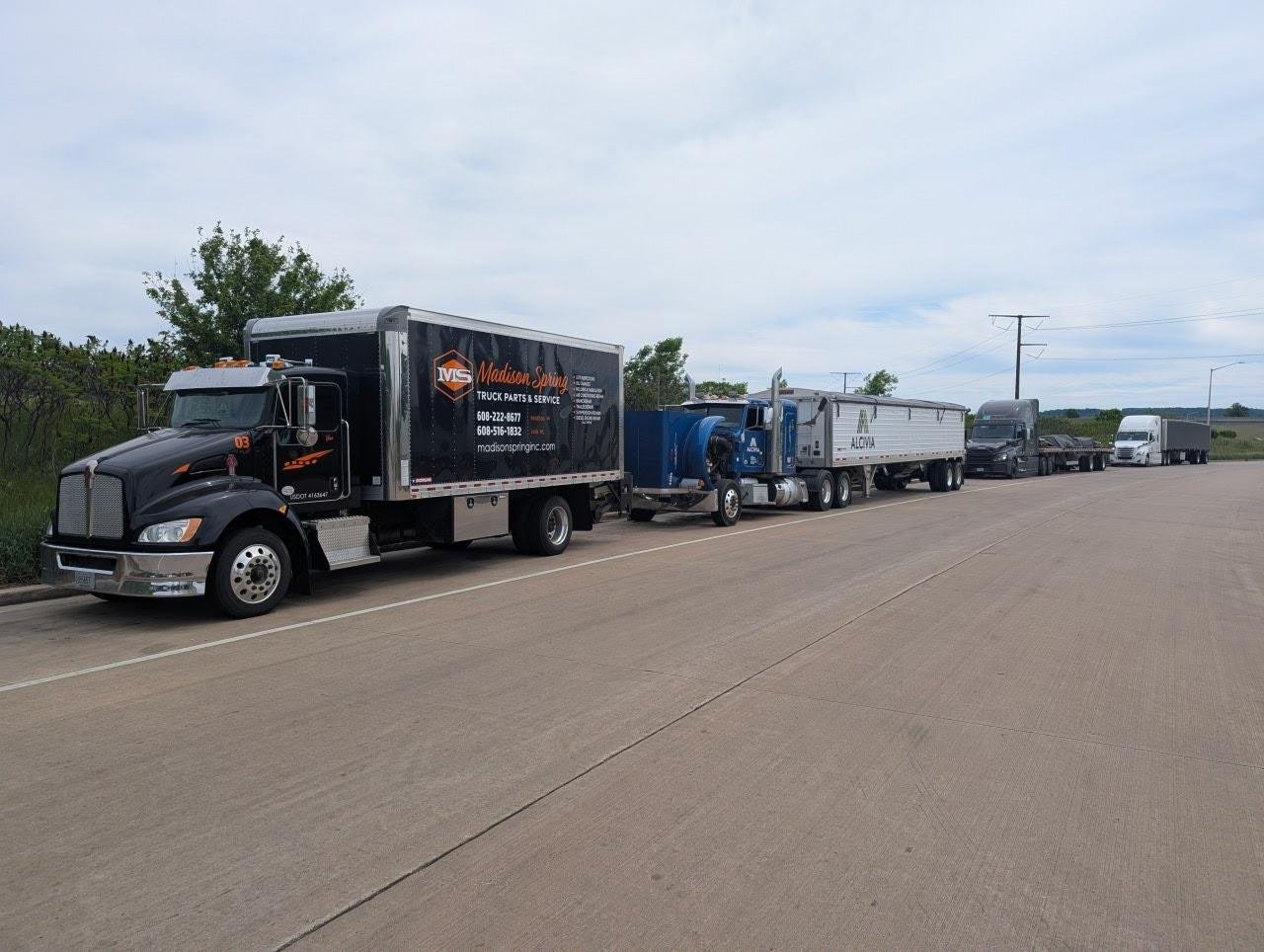 Madison Spring mobile service truck parked with a customer's fleet